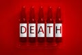 Death of narcotics or drugs addiction concept image. Five ampules with overlay letters of inscription D E A T H. Legal or illegal Royalty Free Stock Photo