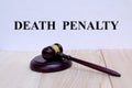 Death Penalty written on the wall with gavel on wooden background. Law concept Royalty Free Stock Photo