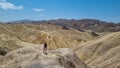 Death Valley - Man with scenic view Badlands of Zabriskie Point, Furnace creek, Death Valley National Park, California