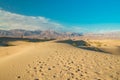 Mesquite Sand Dunes, mountains and cloudy sky background in Death Valley National Park, CA Royalty Free Stock Photo