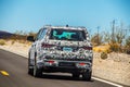 2021_05_25_Death Valley USA - Test Car wrapped with black and white camouflage driving into desert