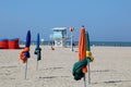 Furled sunshades and a lifeguard tower on Deauville beach Royalty Free Stock Photo