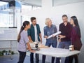 Debating the aspects of the design to ensure perfection. a group of architects discussing plans. Royalty Free Stock Photo