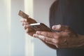 Debit card and mobile phone app online purchase, closeup of male hands using smartphone to complete financial transaction on