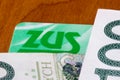 Logo ZUS on ZUS ID card and polish money detail Royalty Free Stock Photo