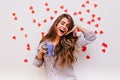 Debonair woman with dark-brown hair smiling in morning. Indoor photo of adorable european girl holding mug with coffee