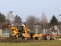 Debowiec/Poland - March 27, 2018: Spring cleaning of green territory in the city. Tractor and excavator for upgrading the green pl Royalty Free Stock Photo