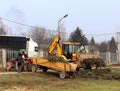 Debowiec/Poland - March 27, 2018: Spring cleaning of green territory in the city. Tractor and excavator for upgrading the green pl Royalty Free Stock Photo