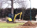 Debowiec/Poland - March 27, 2018: Spring cleaning of green territory in the city. Tractor and excavator for upgrading the green pl Royalty Free Stock Photo