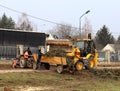 Debowiec/Poland - March 27, 2018: Spring cleaning of green territory in the city. Tractor and excavator for upgrading the green pl Royalty Free Stock Photo