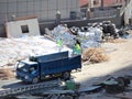 The car takes out garbage after dismantling temporary buildings.