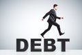 Debt burden concept with businessman running runs on debt word Royalty Free Stock Photo