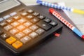 Debt collection and tax season concept on calculator in home off Royalty Free Stock Photo
