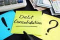 Debt consolidation written by hand and money. Royalty Free Stock Photo