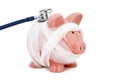 Piggy bank wrapped in gauze with a stethoscope -