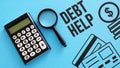 Debt help is shown using the text and picture of coins and photo of calculator Royalty Free Stock Photo