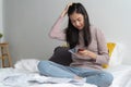 Loan finance crisis concept. Stress woman looking at many bills of credit card on the bed and worrying with personal Royalty Free Stock Photo