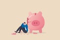 Debt and loan problem, financial mistake, povety or bankruptcy concept, depressed businessman sitting with broken piggy bank Royalty Free Stock Photo