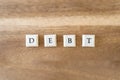 The word Debt on a wooden background.