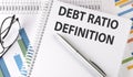 Debt Ratio Definition text on notebook on chart background