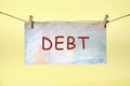 DEBT text on colored paper hanging on a rope with clothespins Royalty Free Stock Photo