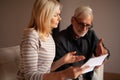 Debt to pay bills. Alarmed mature husband and wife with a letter. Subpoena, financial problems