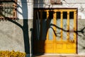 Vintage colourful yellow houses door under sunlight high contrast shadow