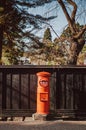 Red vintgae Japanese mail letter postbox and black wooden wall