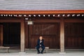 Wooden corridor of Meiji Jingu Shrine with Asain senior guy sit on bench seat - Tokyo Royalty Free Stock Photo