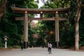 Wooden Torii gate of Meiji Jingu Shrine under big tree in Tokyo Royalty Free Stock Photo