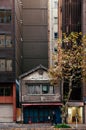 Old small Japanese house among modern buildings in Kanda Tokyo city center - Old world new wolrd concept