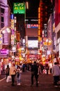 Shinjuku at night vibrant busy street night life with many lightbox signs - Tokyo Royalty Free Stock Photo