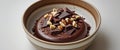 Decadent chocolate dessert topped with nuts and chocolate pieces served in a rustic bowl Royalty Free Stock Photo