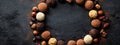 Decadent Chocolate Truffles and Nuts Frame on Dark Slate Background Royalty Free Stock Photo