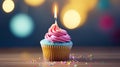 a cupcake with pink frosting and a lit candle Royalty Free Stock Photo