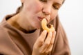 Decadent delight: An attractive woman in her prime relishing the sinful pleasure of a chocolate-covered donut