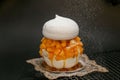 Decadent pavlova topped with slices of juicy maracuya and mango