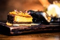 Decadent slice of cake on a rustic wooden board finished with a drizzle of the sweet topping