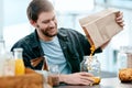 Decant your groceries and send that virus packing. a young man packing his groceries into glass containers after Royalty Free Stock Photo