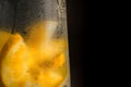 Decanter with cold citrus drink on black background Royalty Free Stock Photo