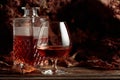 Decanter and glass of brandy on an old wooden table Royalty Free Stock Photo