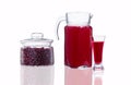 decanter and glass with cranberry juice and a jar with cranberries