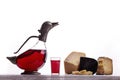 A decanter of red wine, a glass of wine, expensive cheeses, cheese with mold, black cheese. Royalty Free Stock Photo