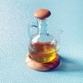 Decanter of virgin olive oil on a wooden stand Royalty Free Stock Photo