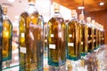 Decanters, whiskey bottles on shelves lined up in glass cabinets
