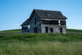 Decaying, abandoned spooky old farmhouse shack in the rolling hills of the Palouse region of Washington State Royalty Free Stock Photo