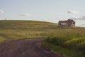 Decaying, abandoned spooky old farmhouse shack in the rolling hills of the Palouse region of Washington State