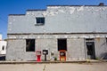 Decaying Urban Facade with Peeling Paint and Newspaper Vending Machines Royalty Free Stock Photo