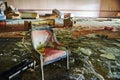 Decaying Vintage Armchair and Piano in Abandoned Hotel - Eye-Level Perspective