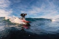 December 28, 2019. Anapa, Russia. Surfer in wetsuit on longboard with sea wave. Winter surfing in Russia